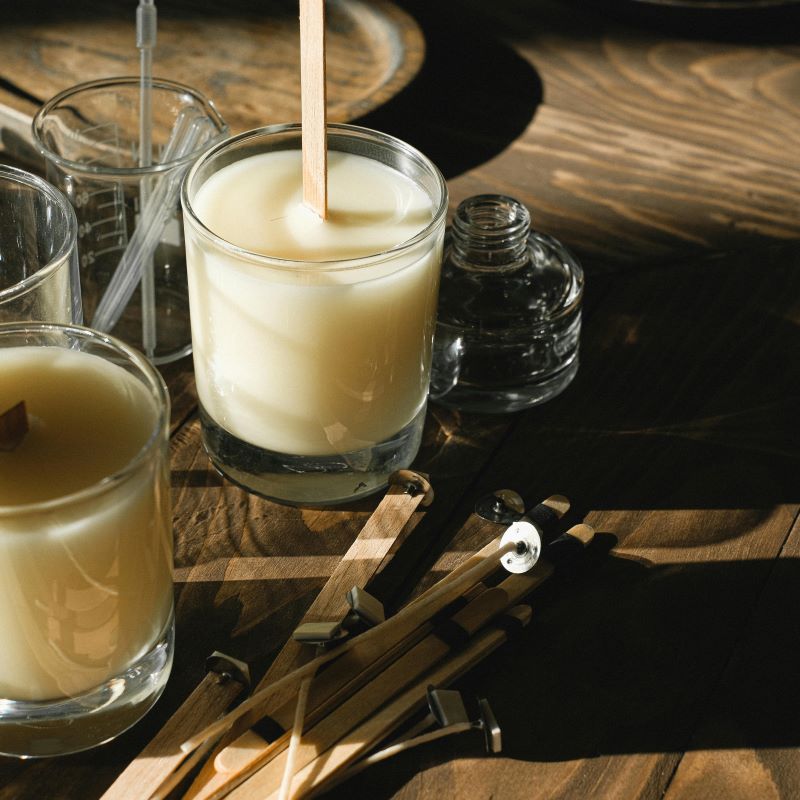 A workspace set up with candle materials.
